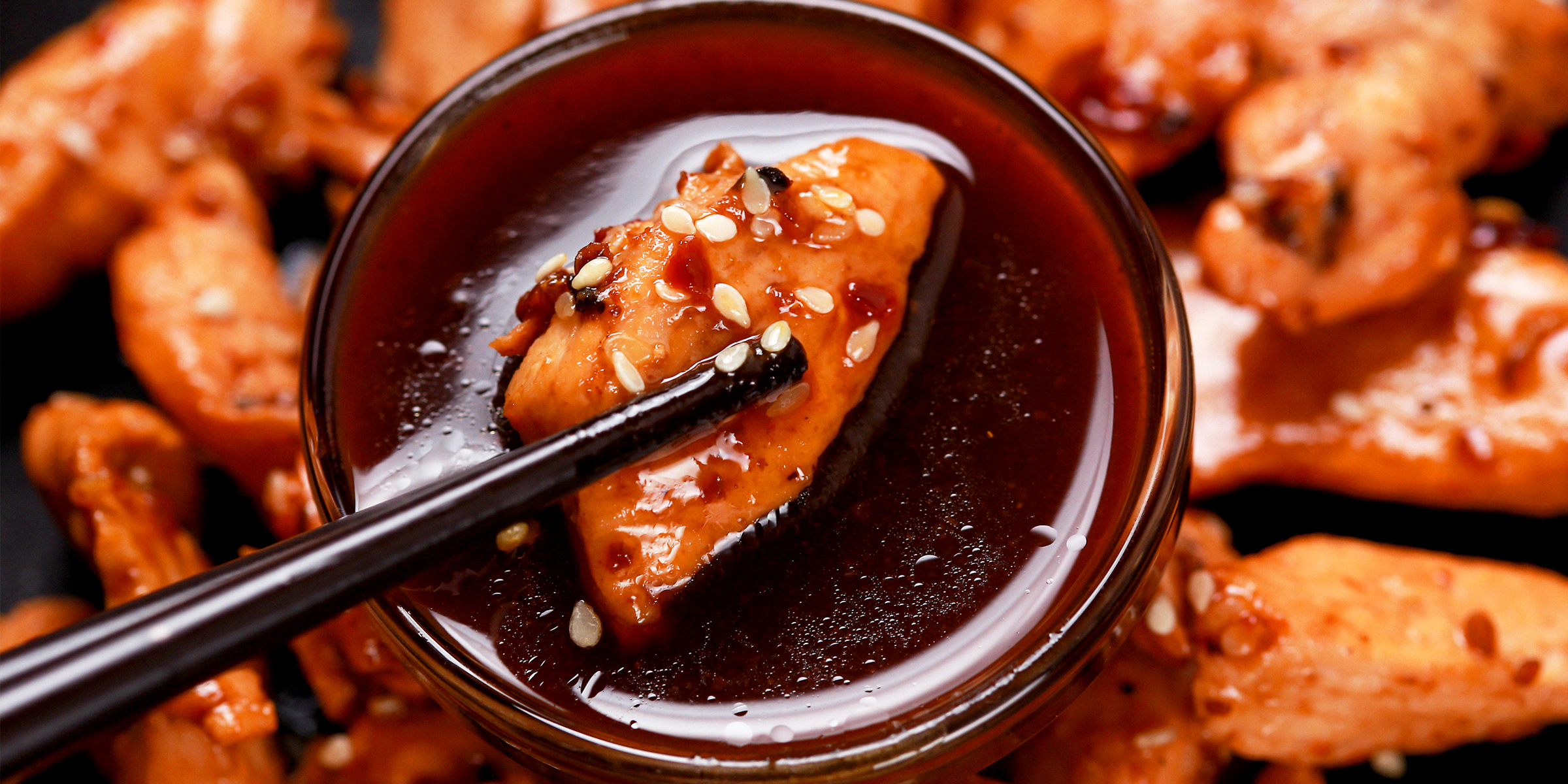 A bite-sized piece of chicken dipped in soyaki sauce | Source: Shutterstock